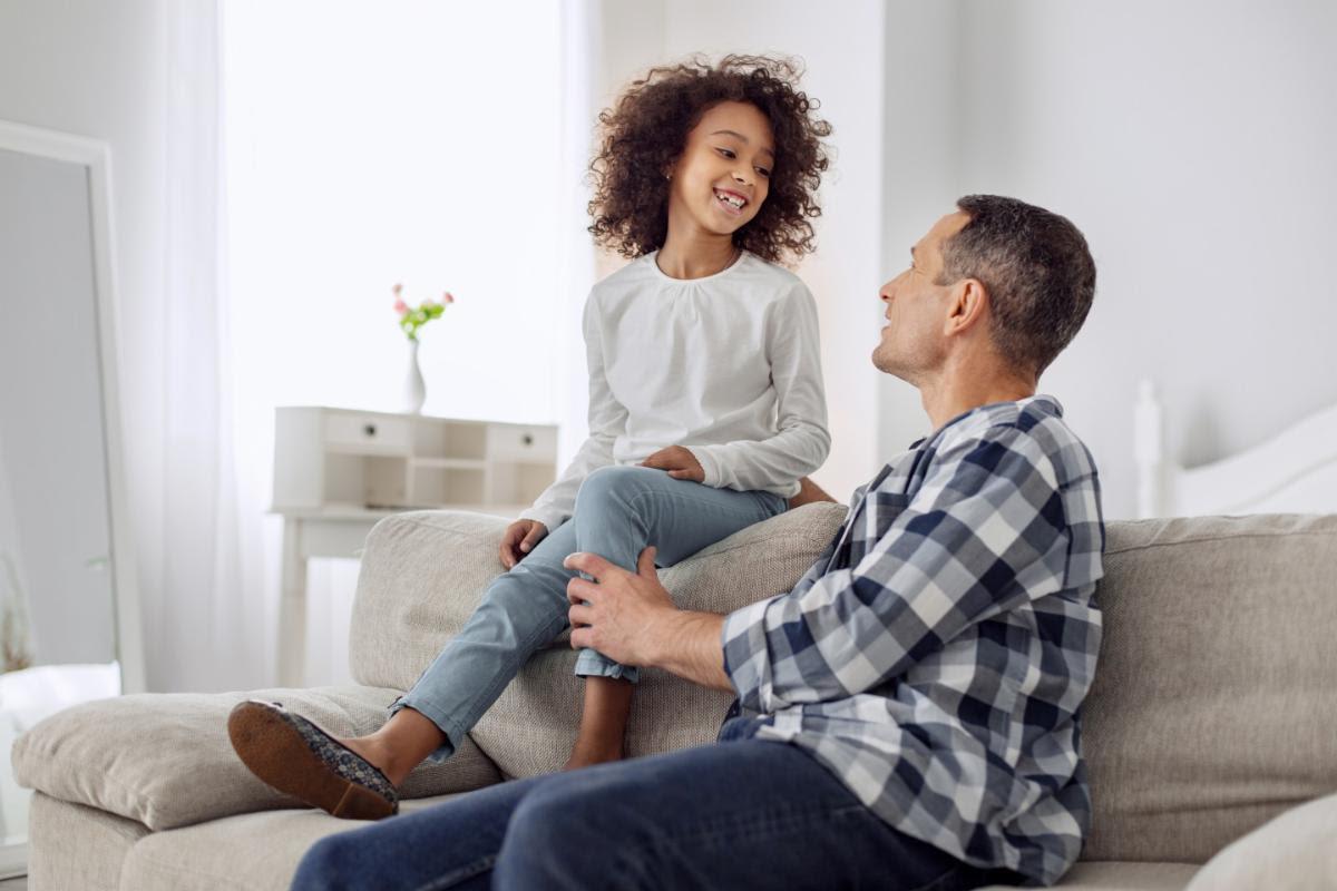 Father talks casually with his daughter.