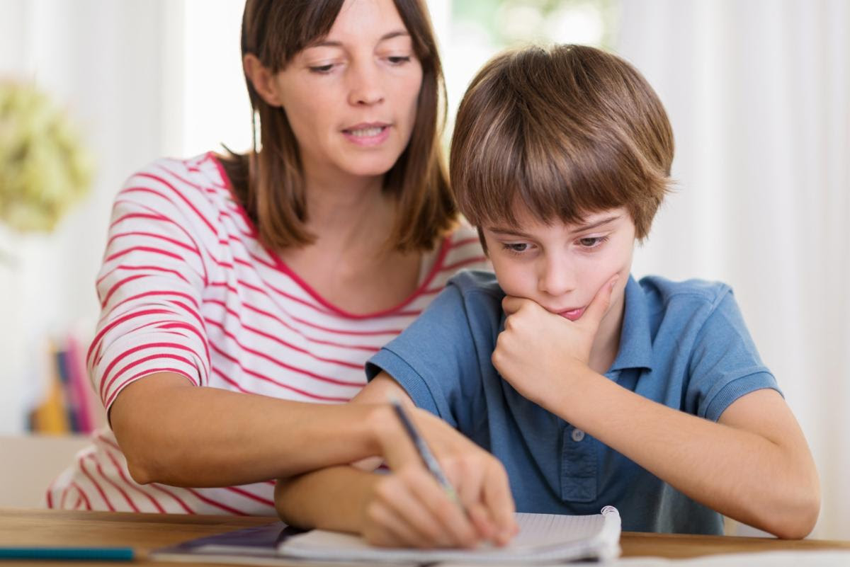 Mother helps her son with homework