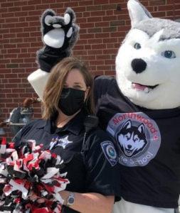 Highland Park Officer Amy Hyndman celebrates Red Ribbon Week with Northwood Middle School's mascot